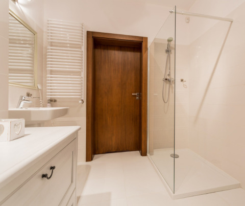 A spacious wet room with underfloor heating and a slip-resistant surface.
